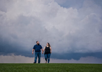 engagement couple walking holding hands on a hill in York Pennsylvania