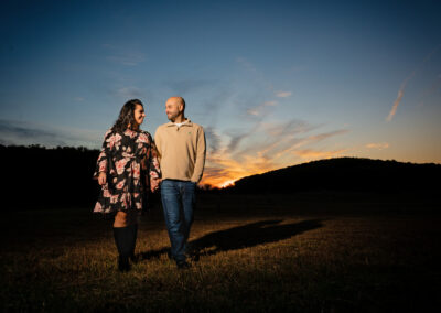 Engaged couple walking during sunset York PA Wedding Photographer